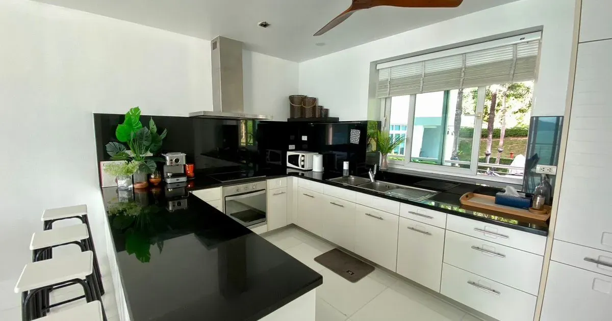 Modern open-plan kitchen featuring a stylish island and breakfast bar.